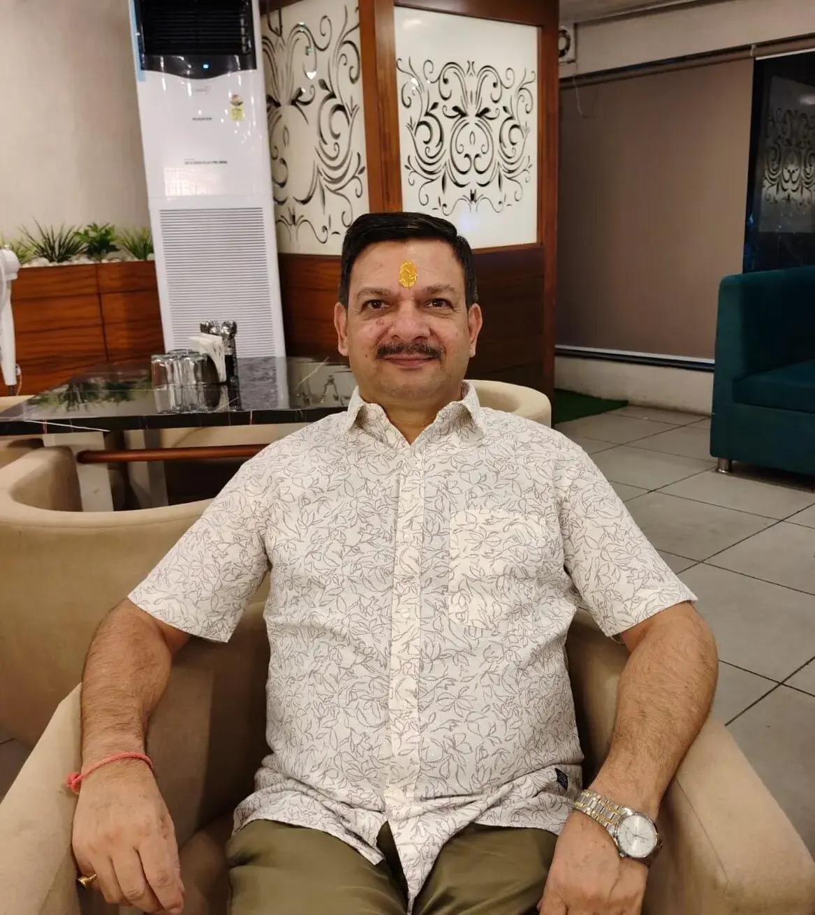 Pankaj Gupta seated in a white patterned shirt